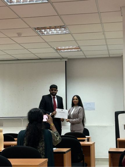 Female student clicking teacher and student's photo in mobile