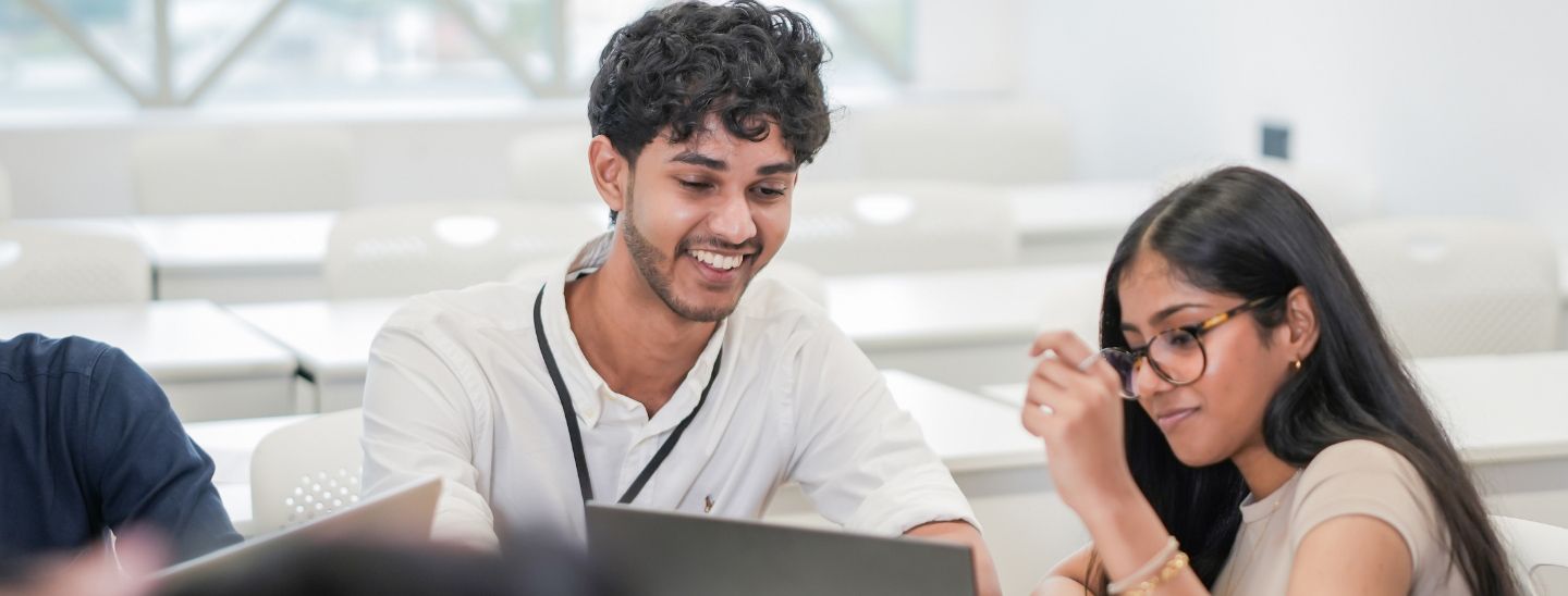 Students watching on laptop screen