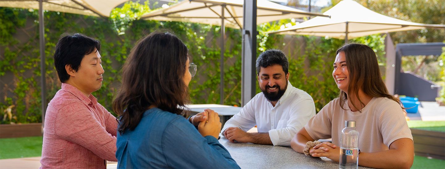 People sitting outside talking happy