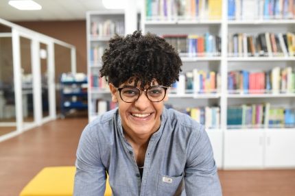 Student inside laughing glasses