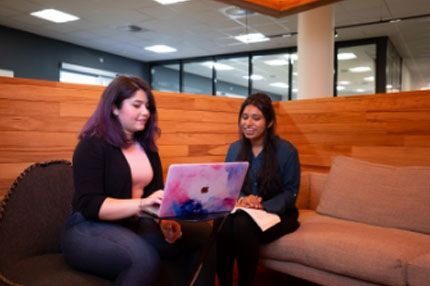 Students working on laptop common area